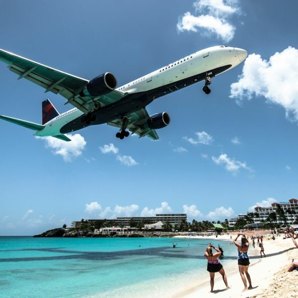 plane landing near seashore during daytime